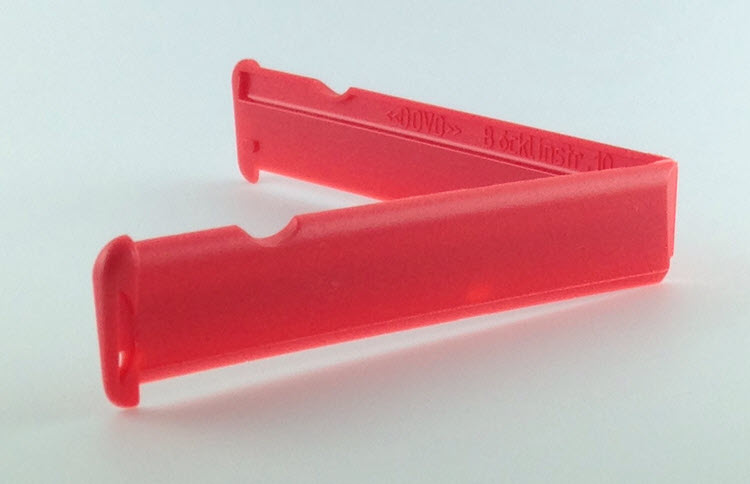 Red insert for a Dovo shavette on an off-white background