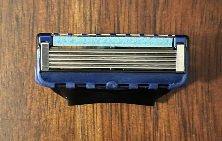 Gillette Fusion Proglide Cartridge on a wood surface.